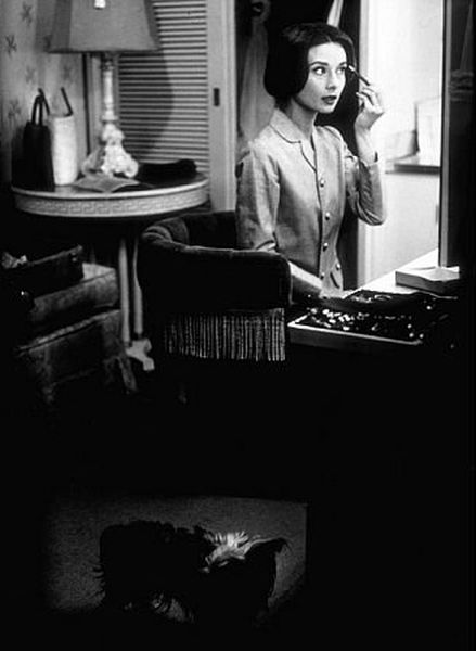 Audrey Hepburn with her pet dog, Famous, in her dressing room at Paramount Studios in Los Angeles, CA, 1957.