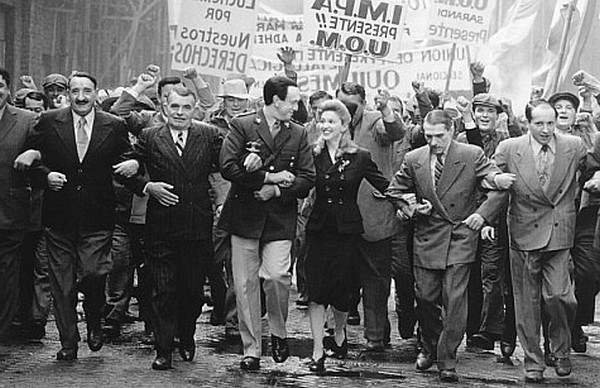 From poor beginnings Eva (Madonna, center left) marries rising political star Juan Peron (Jonathan Pryce, center right) and becomes the most powerful woman in the country.