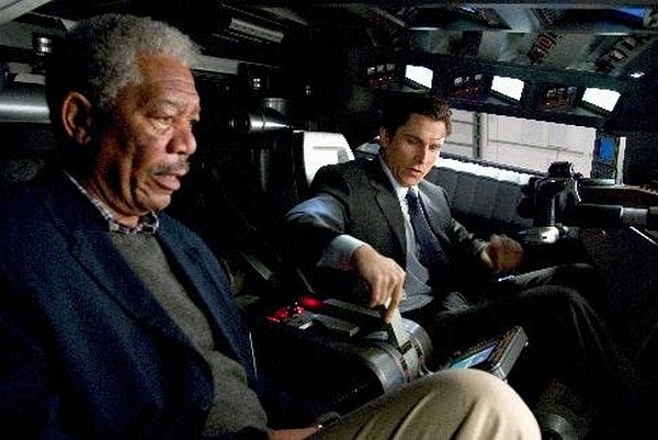 Still of Morgan Freeman and Christian Bale in Batman Begins